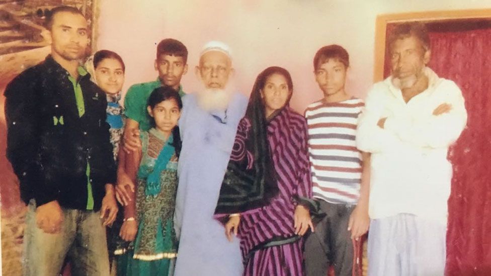 Kamru (centre) with family in Bangladesh