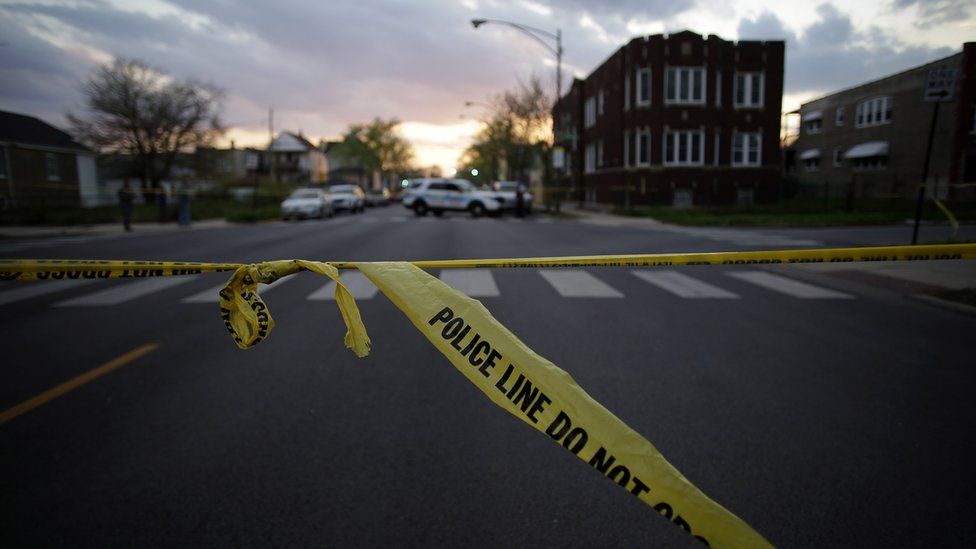 An image of police tape on a Chicago street
