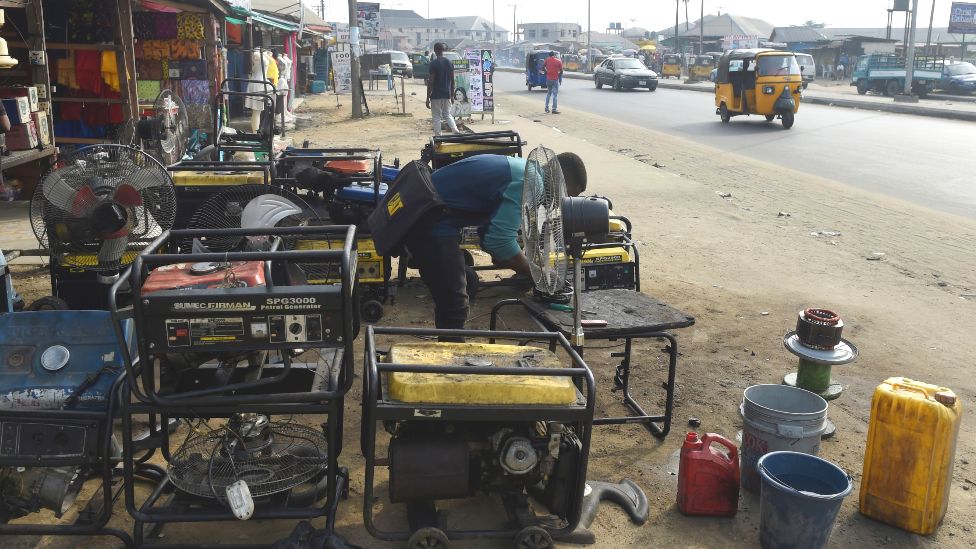 A roadside mechanic repairs electricity generators in Port Harcourt, Rivers state, Nigeria - archive shot