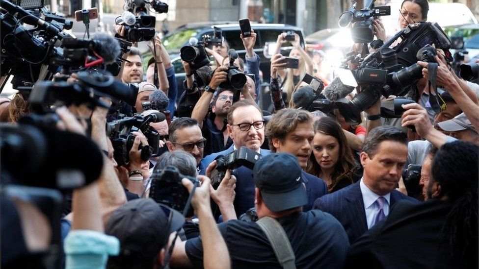 Photographers and camera crews film Kevin Spacey outside Westminster Magistrates' Court