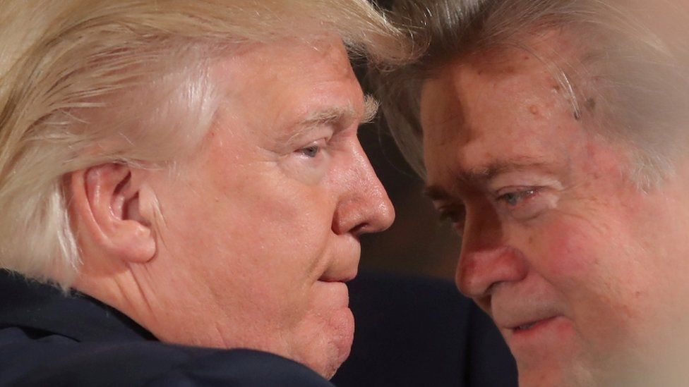 An extreme close up of President Trump learning into Steve Bannon
