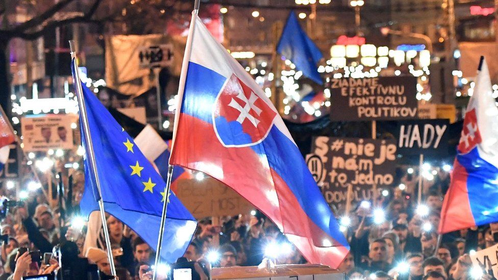 A Slovak flag is held aloft at a rally near the Slovak National Uprising square against corruption and to pay tribute to murdered Slovak journalist Jan Kuciak under the slogan "For a Decent Slovakia", on March 16, 2018 in Bratislava, Slovakia