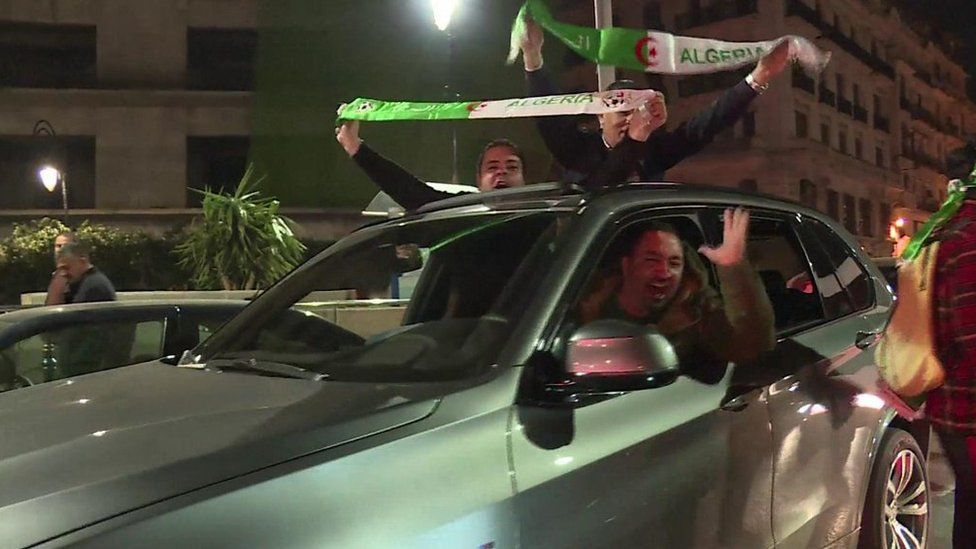 People celebrate in car in Algiers
