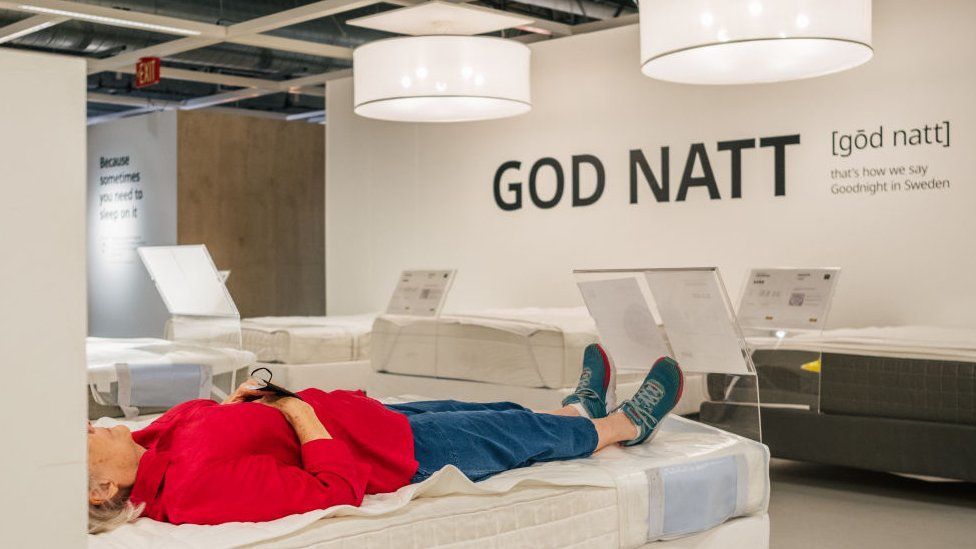 Una mujer descansa en una cama en una tienda IKEA el 10 de junio de 2021 en Houston, Texas.