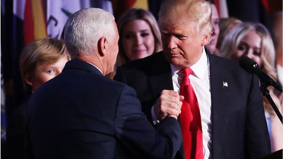 Vice president-elect Mike Pence and Republican president-elect Donald Trump shake hands during his election night event