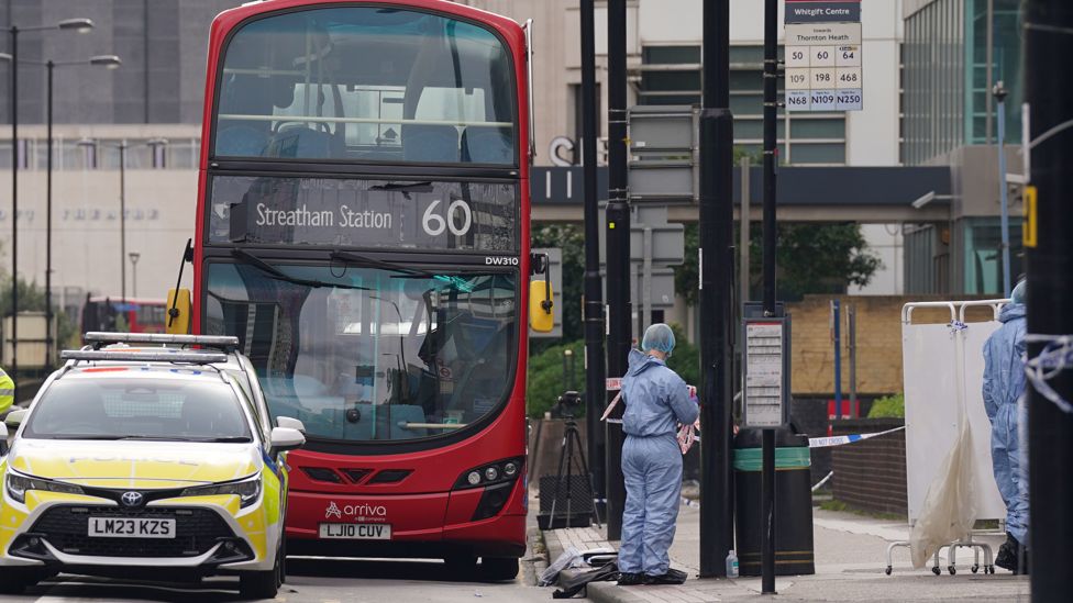 Bus and police car at the scene of the stabbing