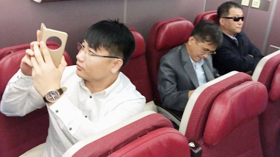 Passengers believed to be North Koreans including Kim Uk Il (L) are seen inside an airplane for the flight bound for Beijing, at an airport in Kuala Lumpur in Malaysia, in this photo taken by Kyodo March 30, 2017.