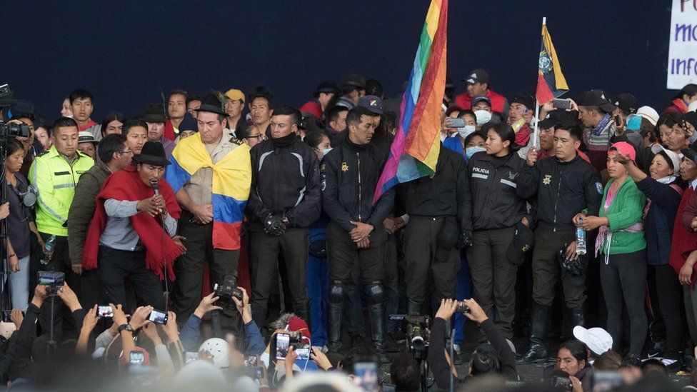 Captive police officers are paraded in front of a crowd of thousands in Quito