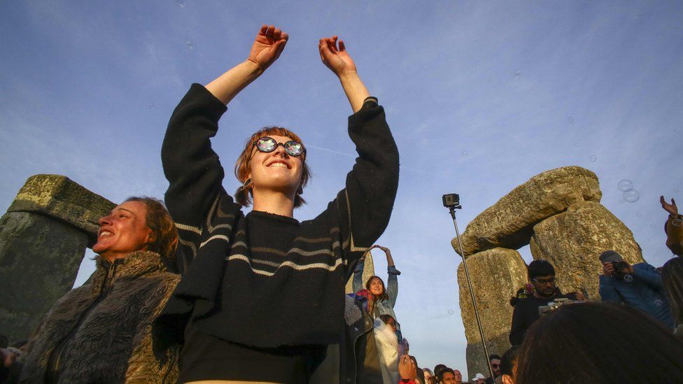 Woman celebrating at Stonehenge