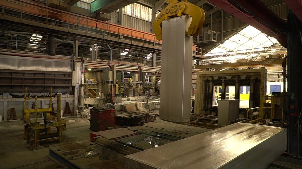 An eight tonne bar of aluminium being lifted by a crane