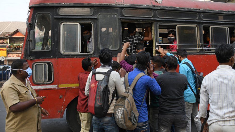 A crowd of people boarding a public transport bus in Mumbai. Covid-19 cases are spiralling in Maharashtra state as people are not maintaining social distance while travelling to work.