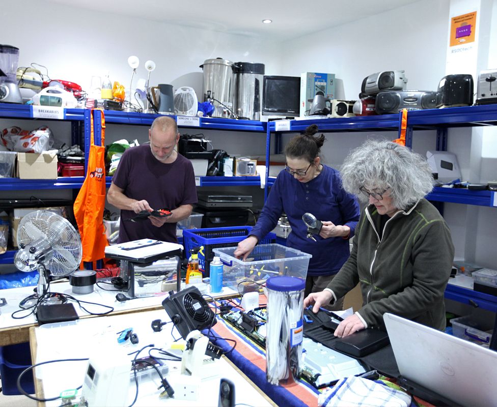 Volunteers repair electrical items at the Fixing Factory in Camden, London