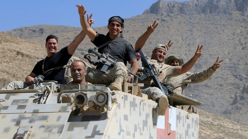 Lebanese army soldiers are seen flashing victory signs in the town of Ras Baalbek, Lebanon August 21, 2017.