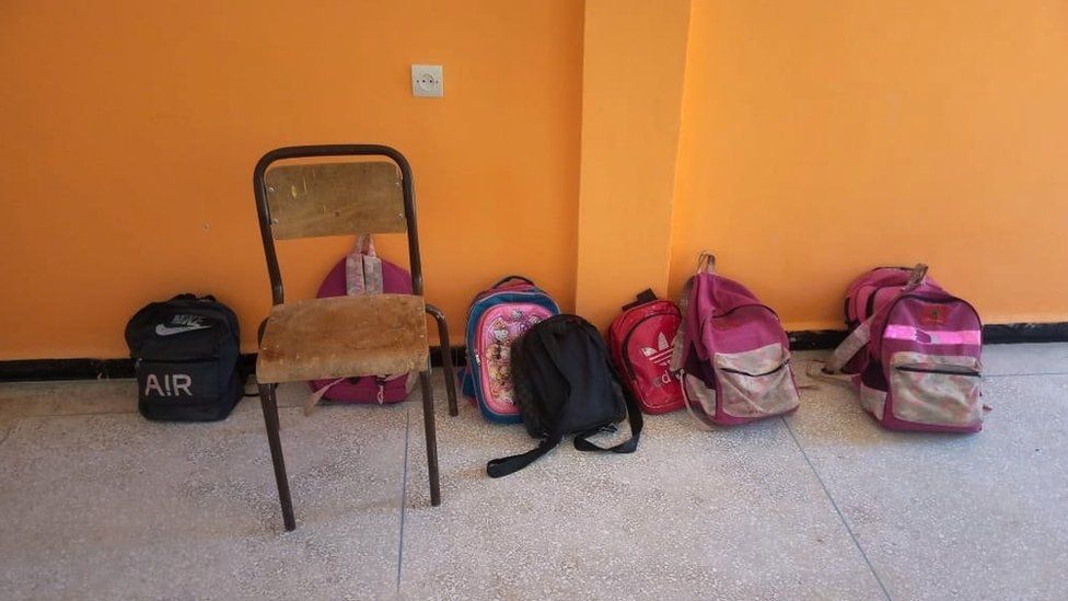 Abandoned school bags and a chair in a school