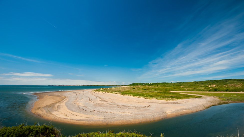 A wide angle shot of Ogmore Beach on a sunny and clear day