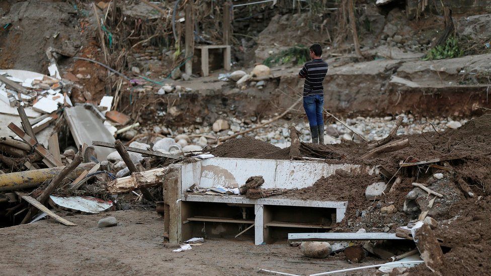 A man looks at a destroyed area after flooding and mudslides caused by heavy rains in Mocoa