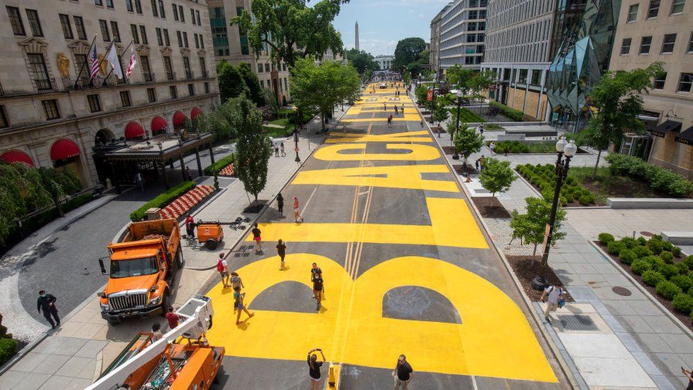 Black Lives Matter painted in yellow on the street leading up to the White House