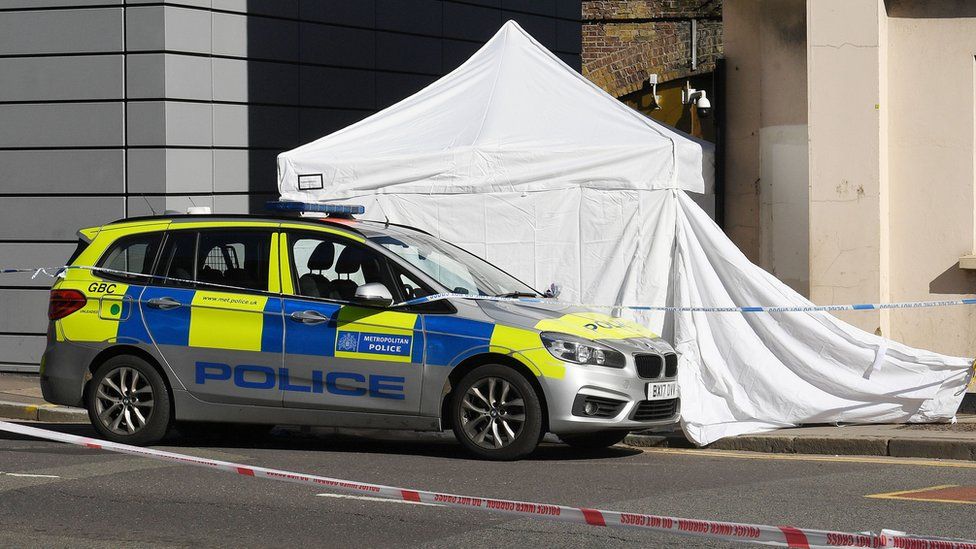 Met Police car parked outside forensics tent