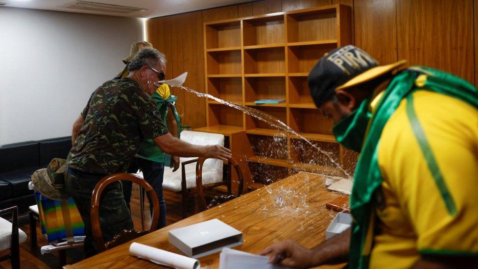 Vandals inside a room in the presidential palace
