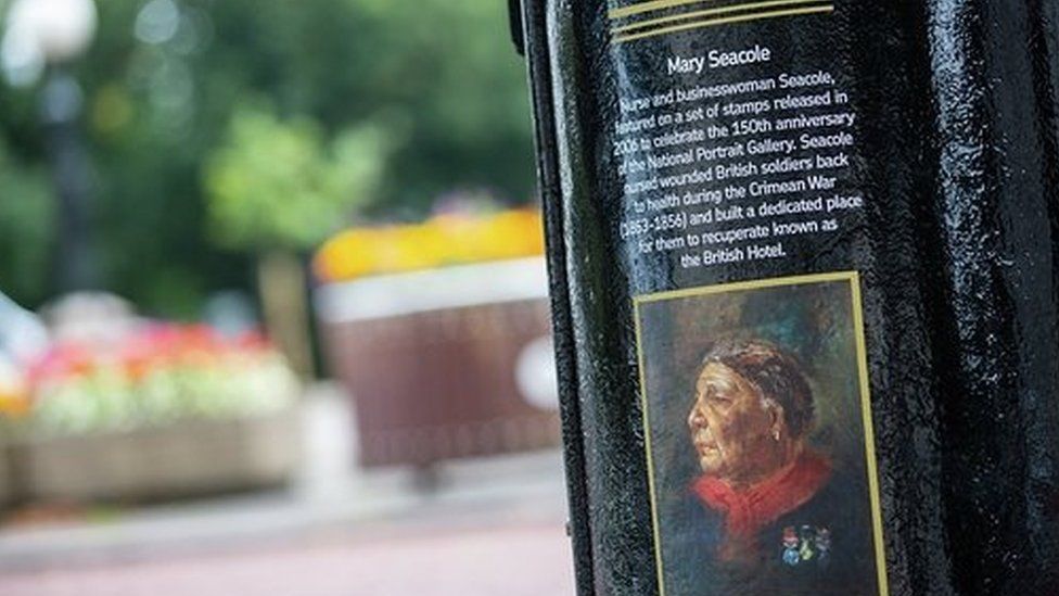 A black postbox featuring an image of Mary Seacole in King Edward VII Avenue, Cardiff