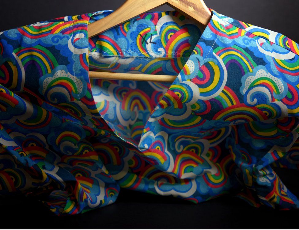 Scrubs in a bright coloured rainbow paisley pattern made by volunteers with an XL label on it