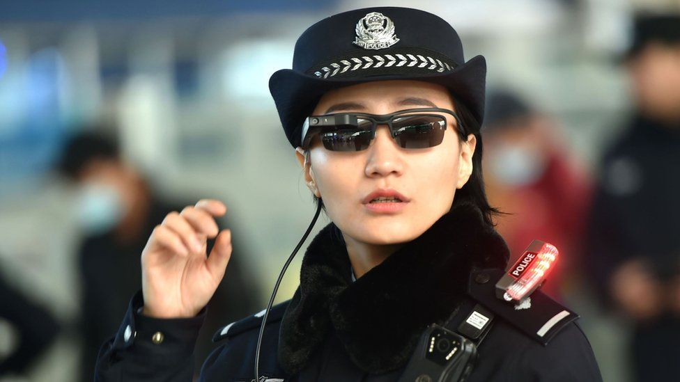 Image shows a police officer wearing a pair of sunglasses with a facial recognition system at Zhengzhou East Railway Station in Zhengzhou in China's central Henan province.