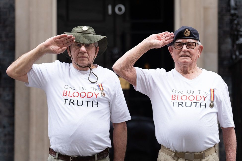 Veterans Terry Quinlan and Brian Unthank salute in front of 10 Downing Street