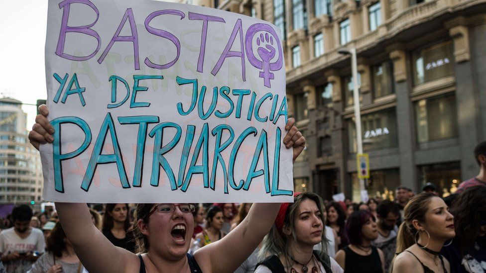 A protester holds a placard that reads "enough of patriarchal justice" during a protest against court's decision to release 'wolf pack' gang on bail. 22 June 2018