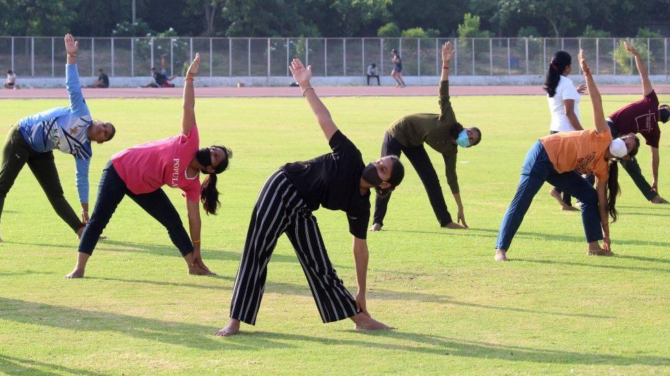 People performing yoga during a preparation of the 7th International Yoga Day at Tau Devi Lal Stadium Sector-38 near Rajiv Chowk, on June 19, 2021 in Gurugram, India.