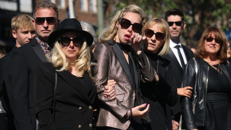 Parker's widow Kelsey (centre) with family members before the funeral