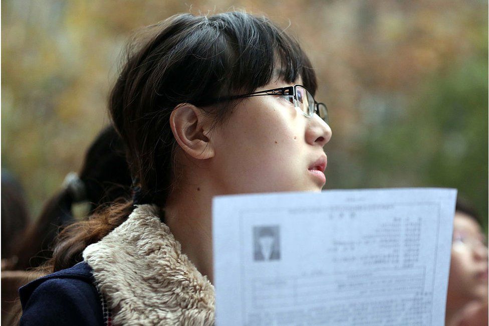 This picture taken on 24 November 2013 shows a candidate arriving for China's national civil service exam in a university in Nanjing, east China's Jiangsu province.