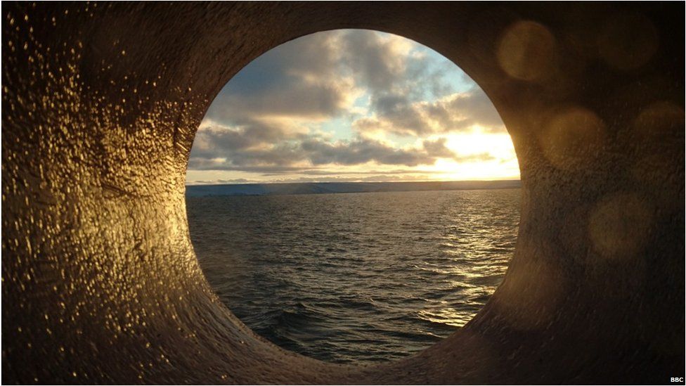View of the Antarctic coast through the window onboard the ship.