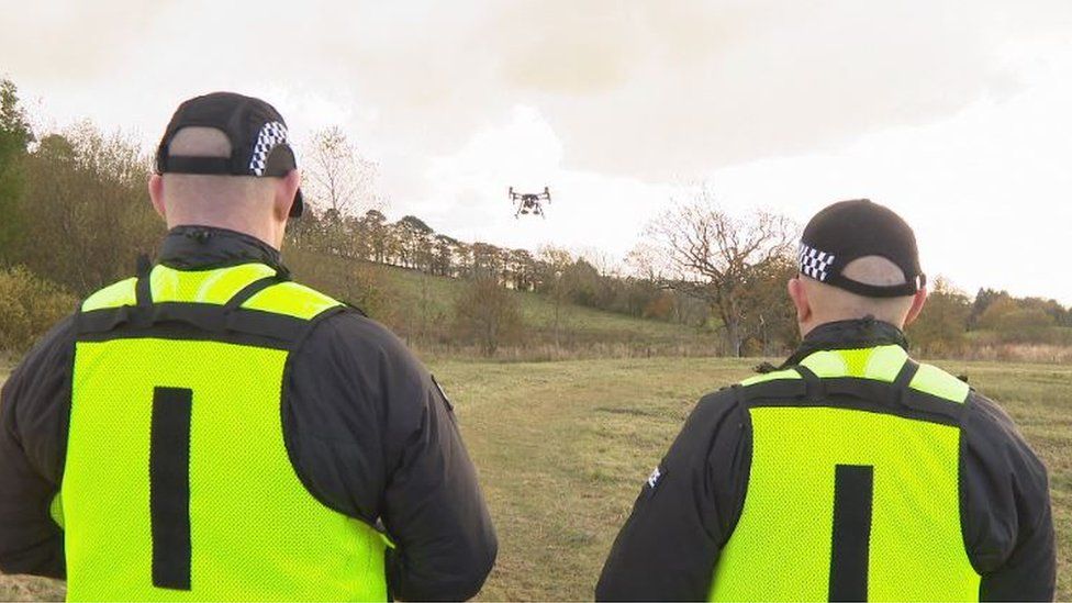 two police officers operate the drone and the data recognition