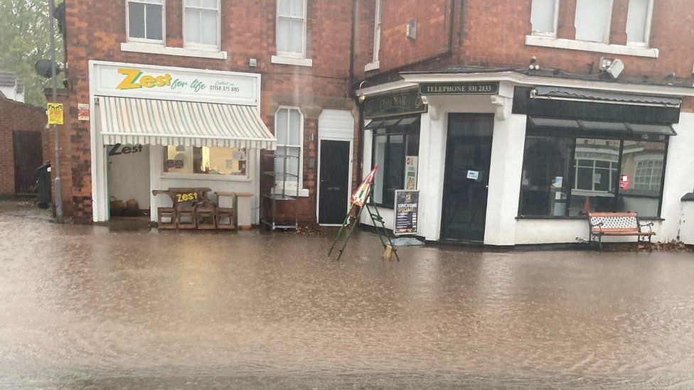 Floods of water outside Zest for Life and Burton Joyce Fish Bar