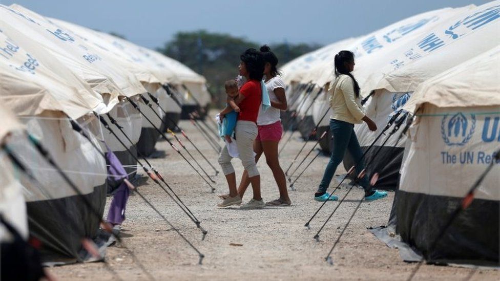 Venezuelan migrant women walk through a camp run by the UN refugee agency UNHCR in Maicao, Colombia May 7, 2019