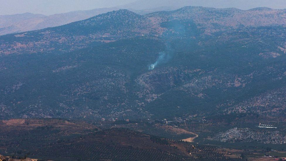 Smoke rises in Kfar Shouba, as seen from the village of Khiam, southern Lebanon, near the border with Israel (6 July 2023)