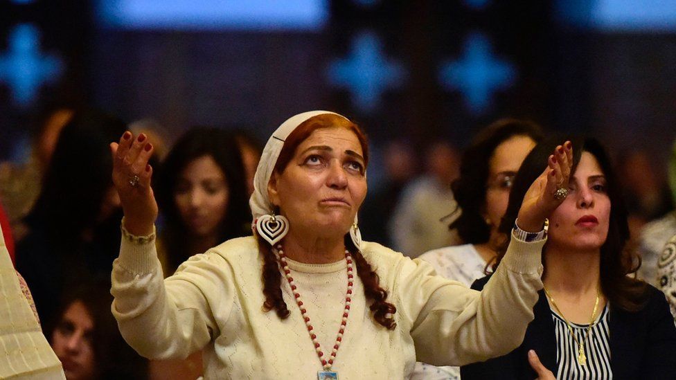 Egyptian women takes part in an Easter mass led by of Egypt"s Coptic Christian, Pope Tawadros II at the Saint Mark"s Coptic Cathedral, in Cairo"s al-Abbassiya district late on April 15, 2017
