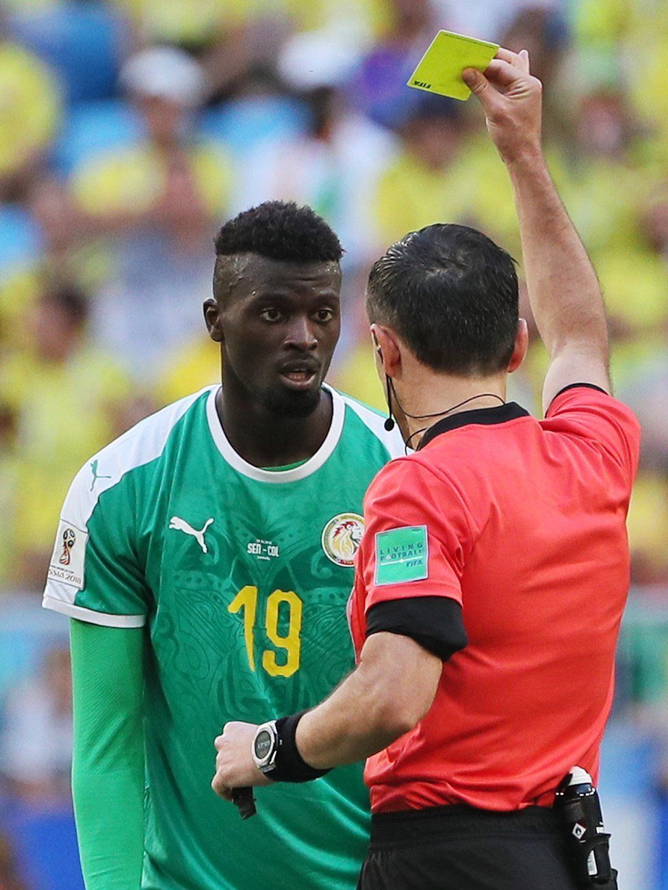 Mbaye Niang of Senegal is shown the yellow card