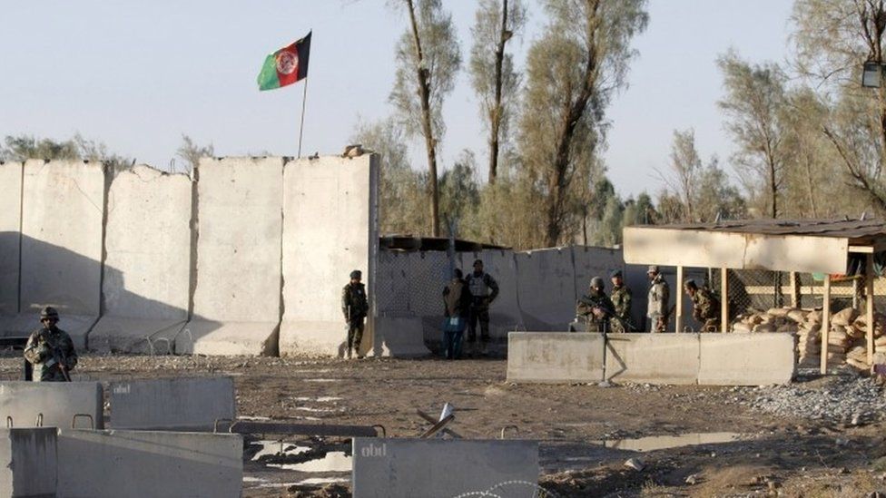 Afghan security forces stand guard at the entrance gate of Kandahar Airport (09 December 2015)