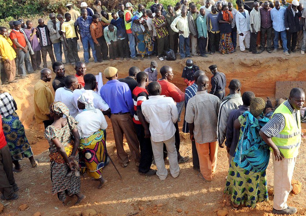 People in Dogo Nahaw, a village south of Jos, gather at the scene of a mass burial of their kinsmen killed during a religious crisis in March 2010
