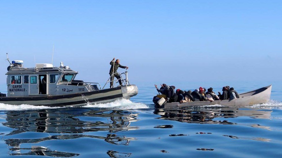 Tunisian coast guards try to stop migrants at sea during their attempt to cross to Italy, off the coast off Sfax, Tunisia April 27, 2023