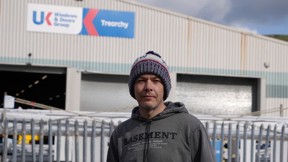 Darren Rees standing in front of the UK Windows and Doors site in Treorchy