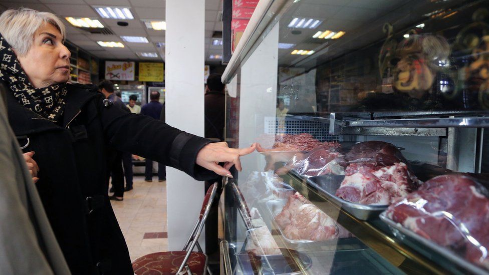 An Iranian woman buys meat a butcher's shop in Tehran (12 February 2019)