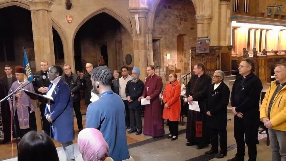 Faith leaders from Bradford stood behind young people - some who had been refugees from other countries