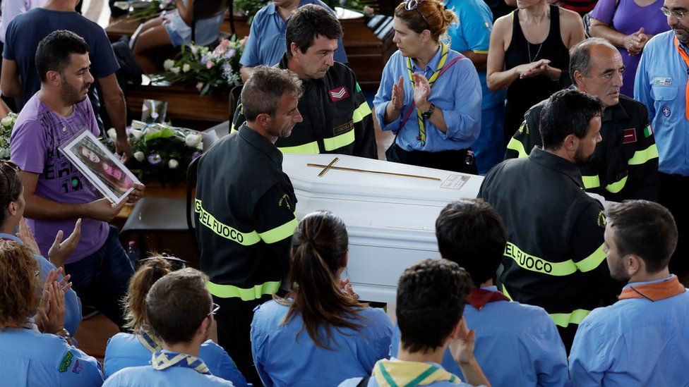 Firefighters carry Giulia's coffin