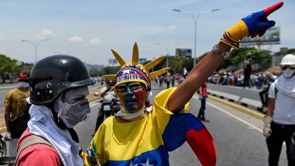 Anti-government protesters take part in a march in Caracas