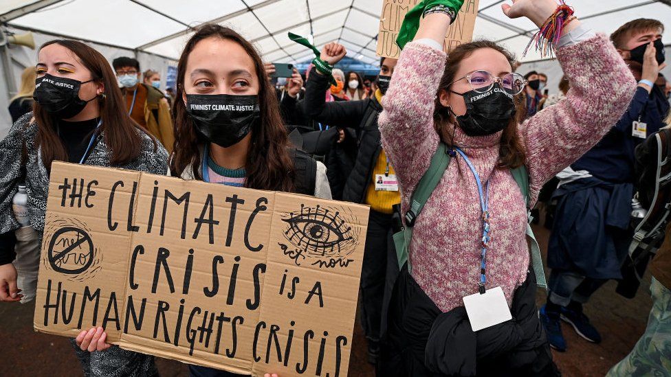 Protesters move through restricted Blue Zone area of COP26 climate summit on November 12, 2021 in Glasgow, Scotland.