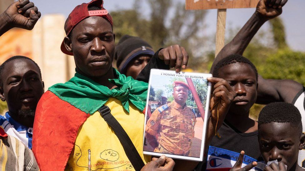 Demonstrators gathering in Ouagadougou to show support to the military hold a picture of Liutenent Colonel Paul-Henri Sandaogo Damiba the leader of the mutiny and of the Patriotic Movement for the Protection and the Restauration (MPSR) on January 25, 2022