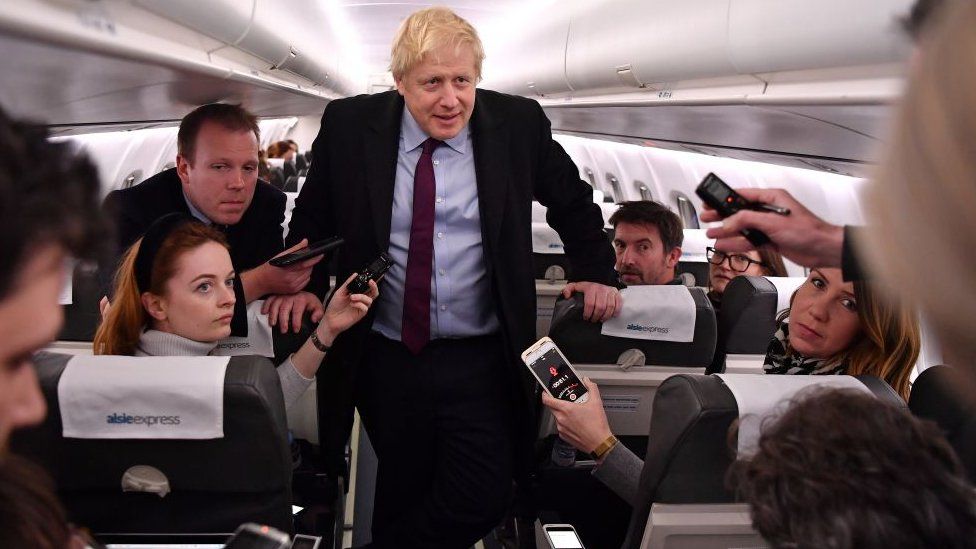 Boris Johnson talking to journalists on an airplane