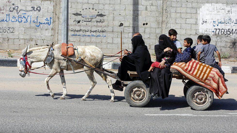 Palestinians leaving Gaza City on a cart